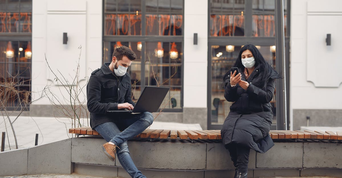 Why didn't Doctor Strange use the Time Stone to prevent Thanos from claiming other Infinity Stones? - Young couple wearing medical masks with laptop and smartphone on city street
