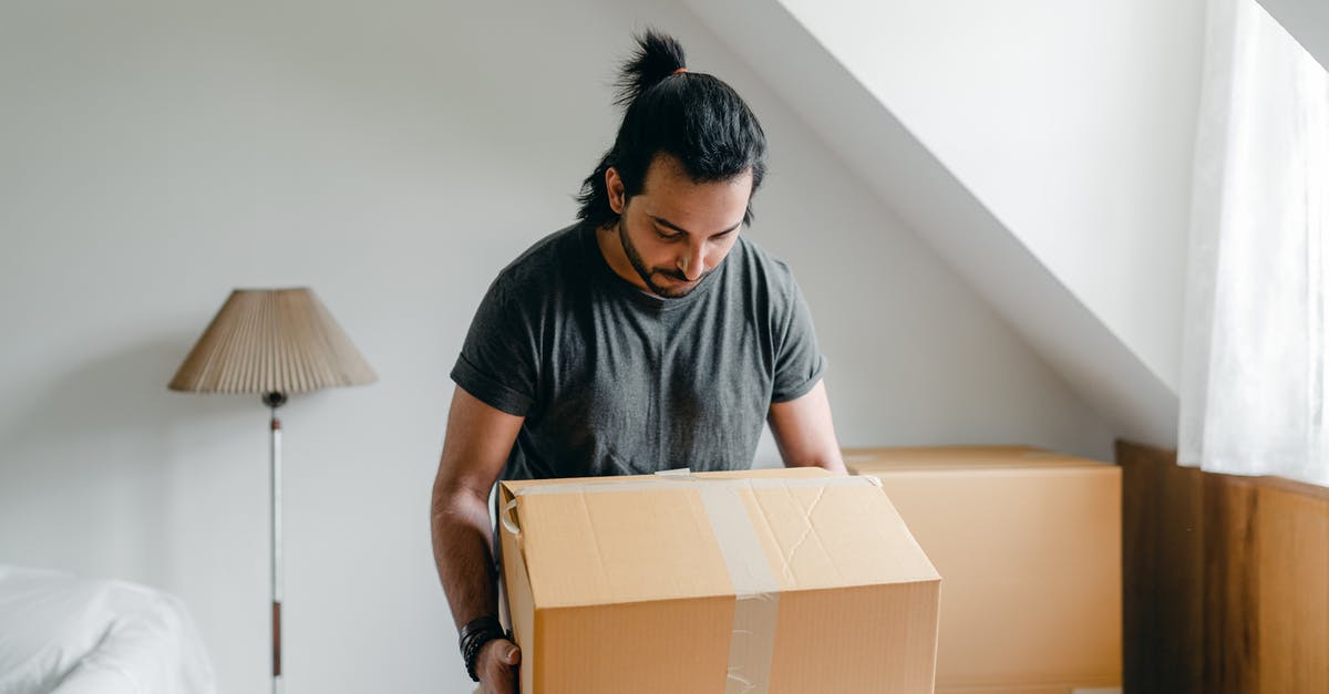 Why didn't Ego take her to his planet? - Ethnic guy picking up cardboard box in house