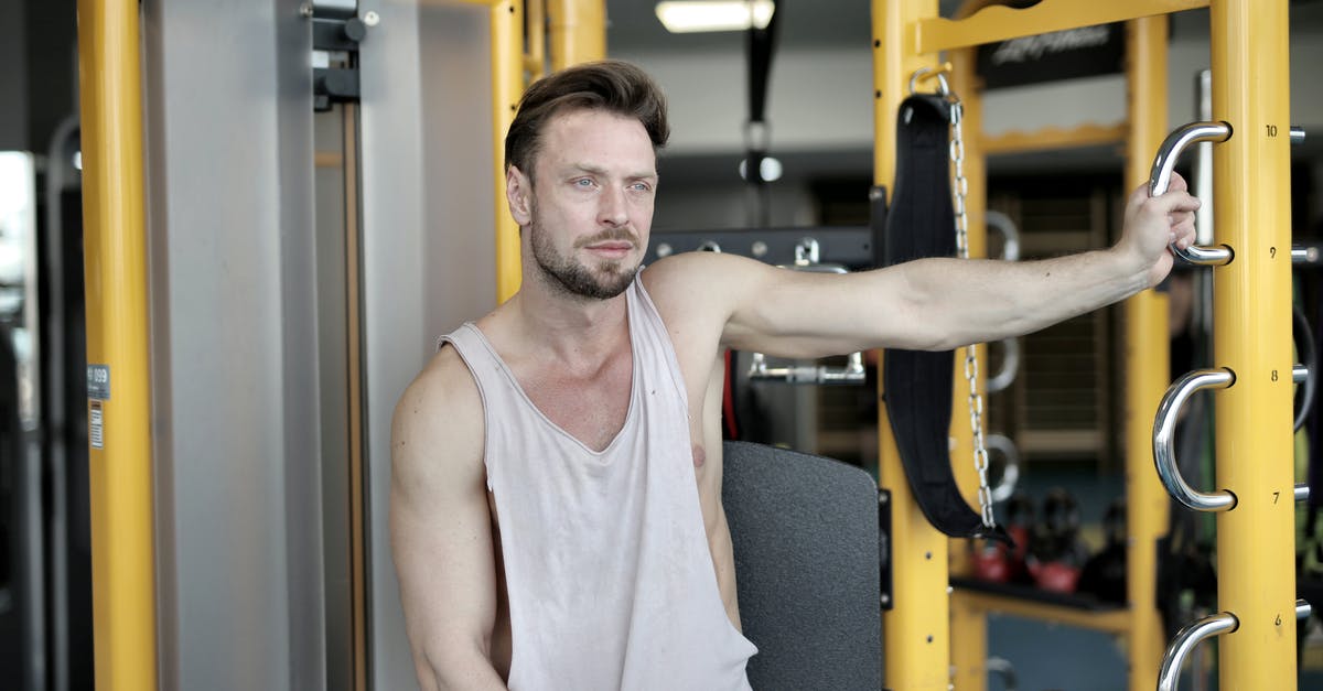 Why didn't he get the power of Mjolnir? - Serious bearded male athlete in casual sportswear sitting near modern exercise machine during break in workout in modern fitness center and looking away
