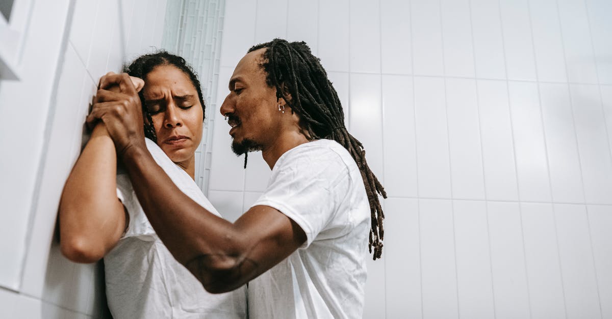 Why didn't Jason kill his last victim? - Side view of young black angered man with Afro braids in white t shirt pushing sad wife with closed eyes against tiled wall during conflict in bathroom