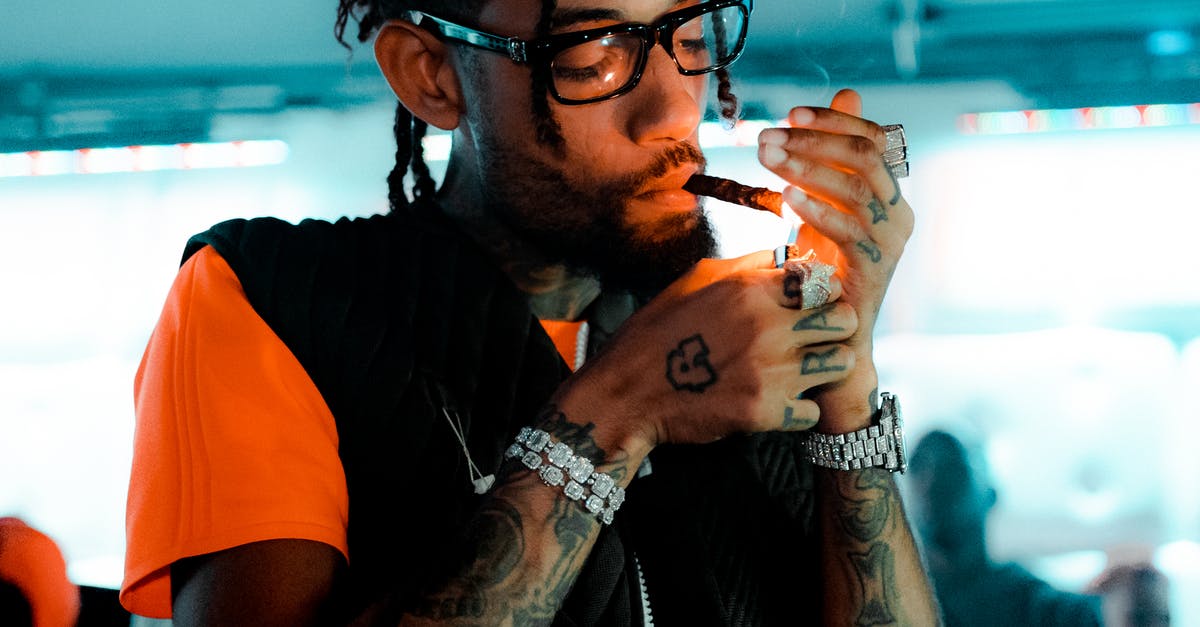 Why didn't Nick Naylor ever smoke in "Thank You for Smoking"? - Stylish tattooed black man lighting cigarette