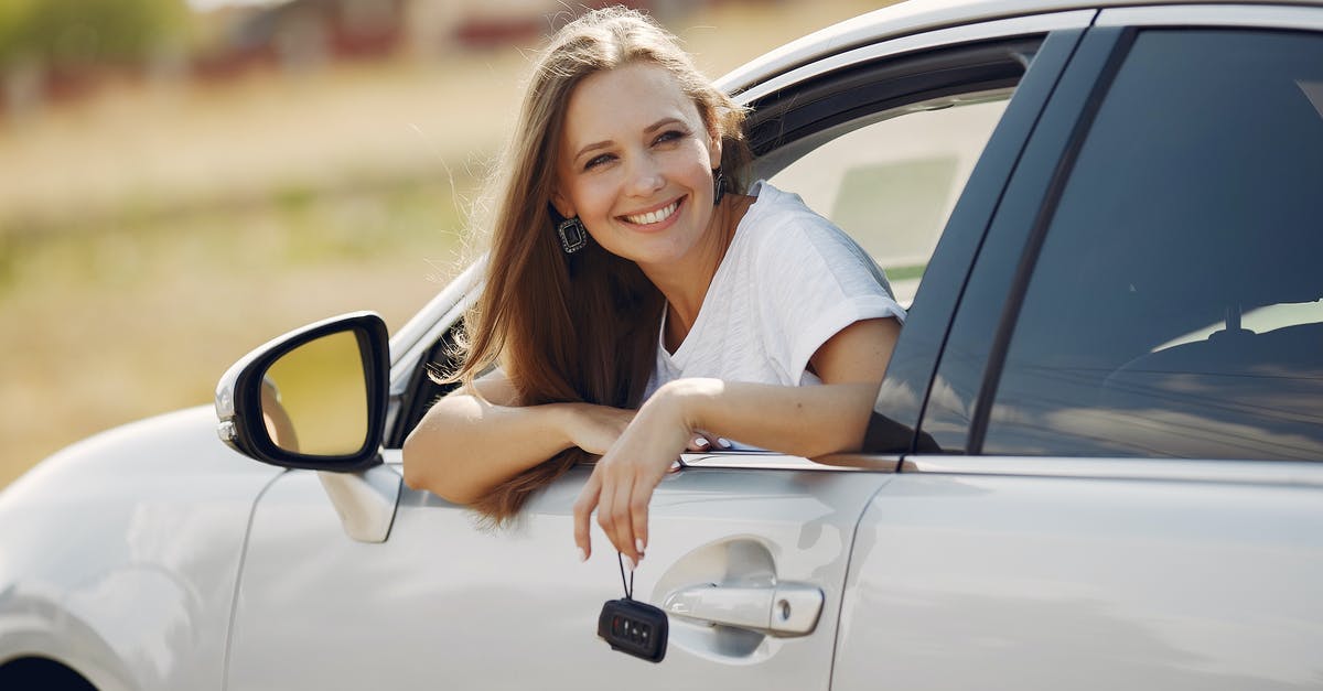 Why didn't R and Julie just drive away? - Happy woman with car key in modern automobile during car trip