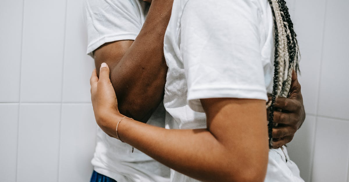 Why didn't Sidney trust Randy? - Side view of crop faceless African American male in white t shirt embracing upset young girlfriend with long braids while standing together in light bathroom