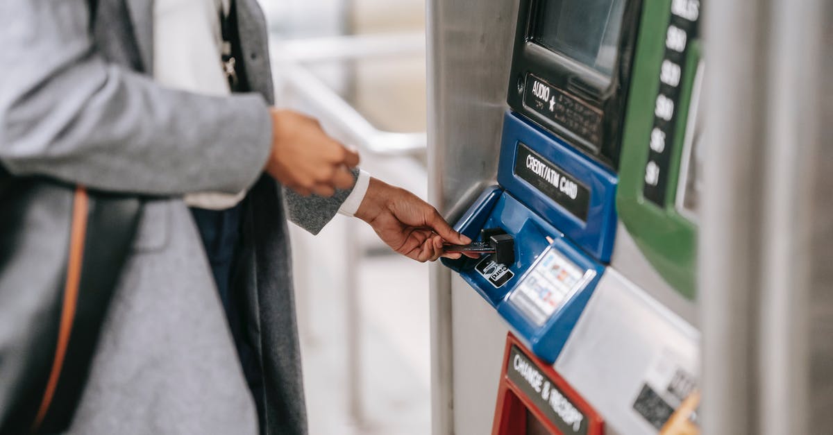 Why didn't Tesla use his machine to make money before selling it to Angier? - Side view of crop unrecognizable female in stylish clothes using credit card while buying metro ticket via electronic machine