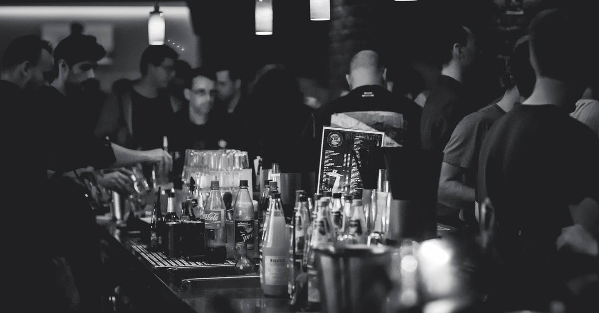 Why didn't the bartender allow Robbie Hart to drink at the bar? - Grayscale Photography of Bottles on Top of Table