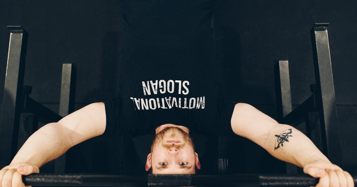 Why didn't the Demogorgon bring Jonathan to the Upside Down? - Bearded sportsman in t shirt with inscription exercising with weight while looking at camera