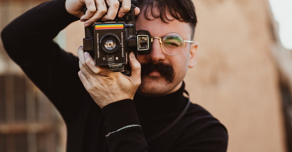 Why didn't the Dominators take up Mick Rory, a non-metahuman, while taking up the Team Arrow? - Male Photographer with Big Mustache Taking Photo with Vintage Camera