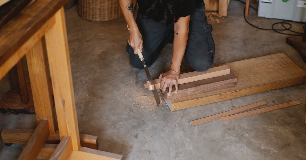 Why didn't the Japanese cut the ropes in Hacksaw Ridge? - Anonymous joiner working with Japanese saw while cutting edge of timber plank on floor in workshop
