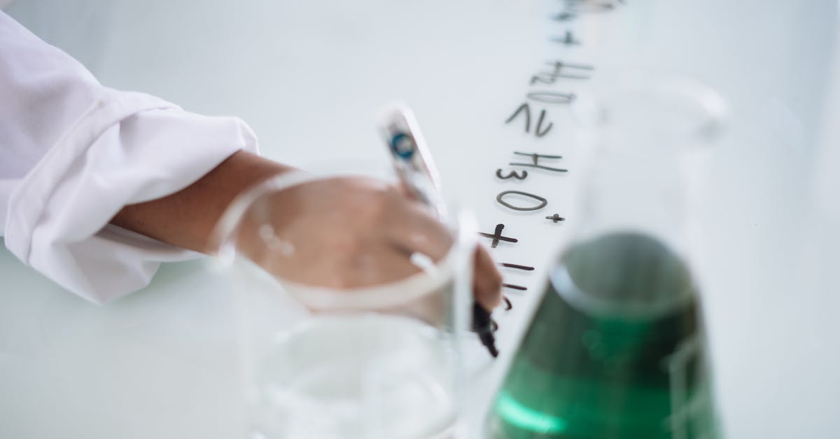 Why didn't the scientist destroy the formula? - Body part of unrecognizable scientist in white uniform writing down formula after providing chemical research with fluid in flask during science lesson in university