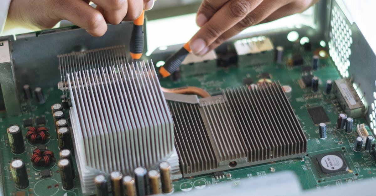 Why didn't the tech staff find any faults in their system check when the chip was removed? - Crop technician checking contacts on motherboard in workshop