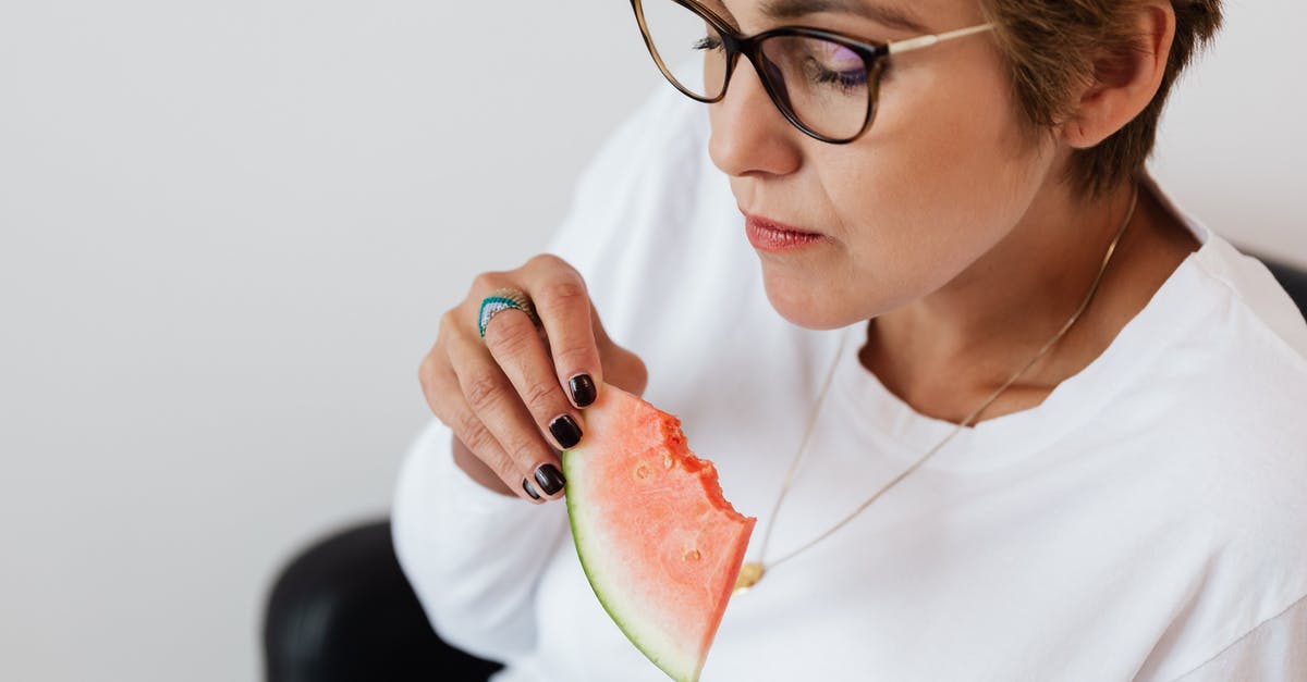 Why didn't the zombies eat her initially? - Crop adult lady eating tasty watermelon at home