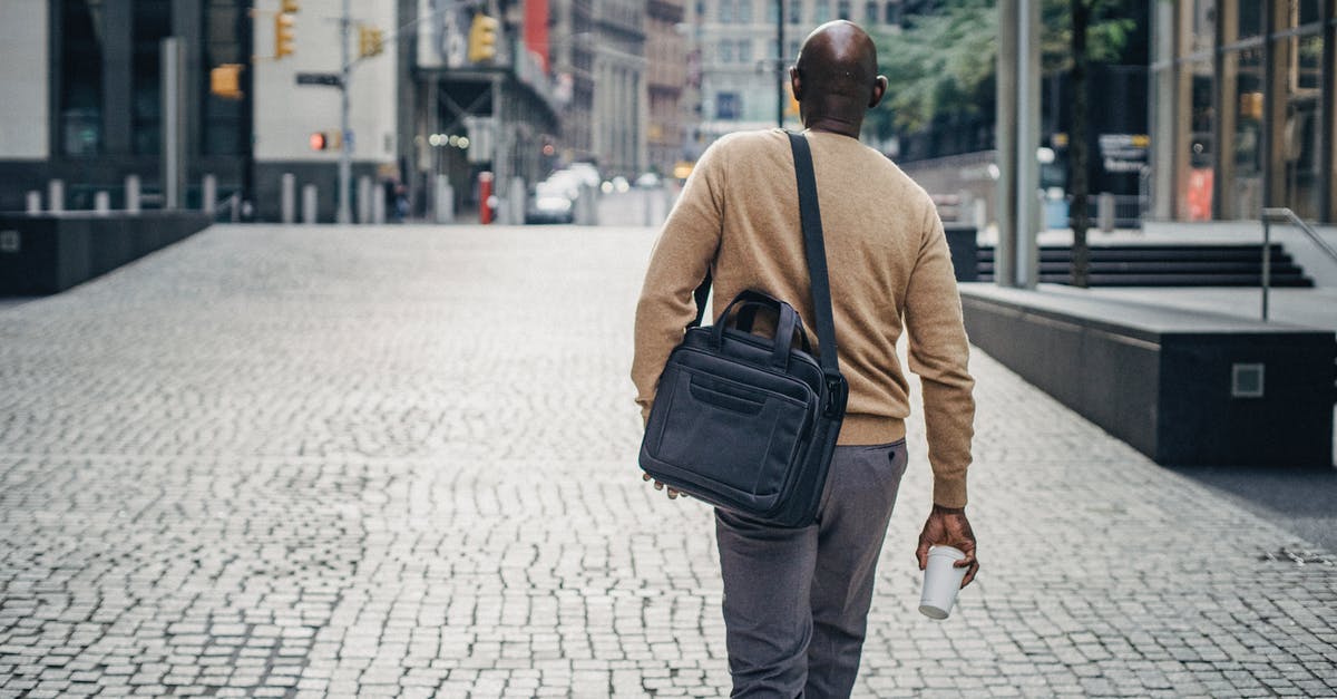 Why didn't they go through with taking the case to the feds? - Black man walking on street with coffee and bag