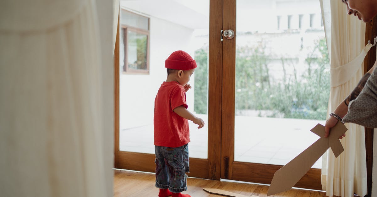Why didn't they use the sword they had? - Boy in Red T-shirt and Blue Denim Shorts Standing Near Brown Wooden Framed Glass Door