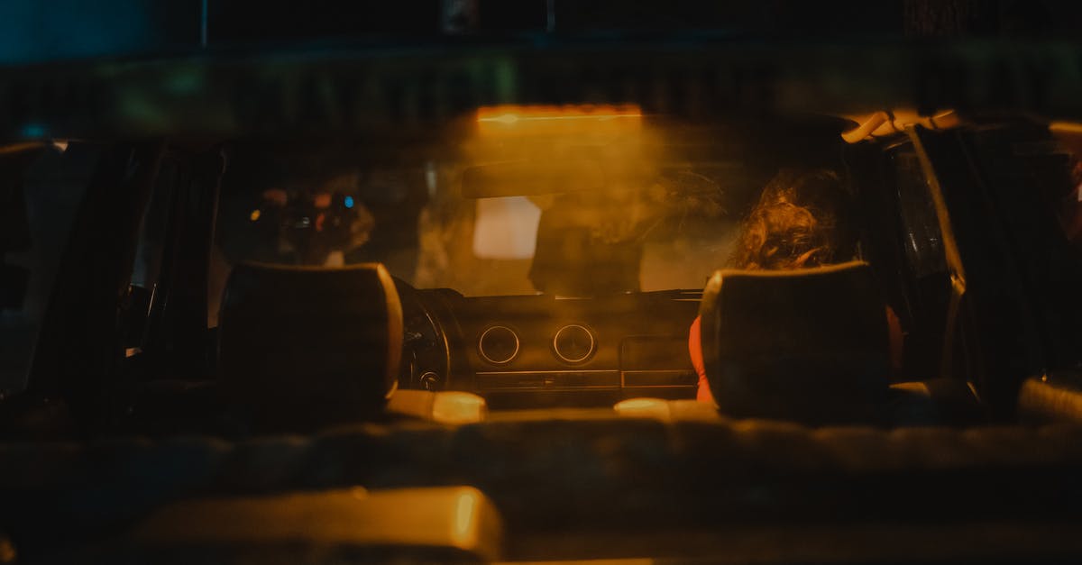 Why didn't Tobey tell the police that Julia could confirm Dino was with them before the illegal race? - Through glass of rear window of auto with shining light illuminating under dashboard at night
