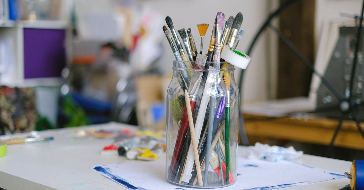 Why didn't Tony Stark take back his Mark 2 Armor that was used to create War Machine? - Glass jar with paintbrushes on desk with paint tubes in professional art workshop