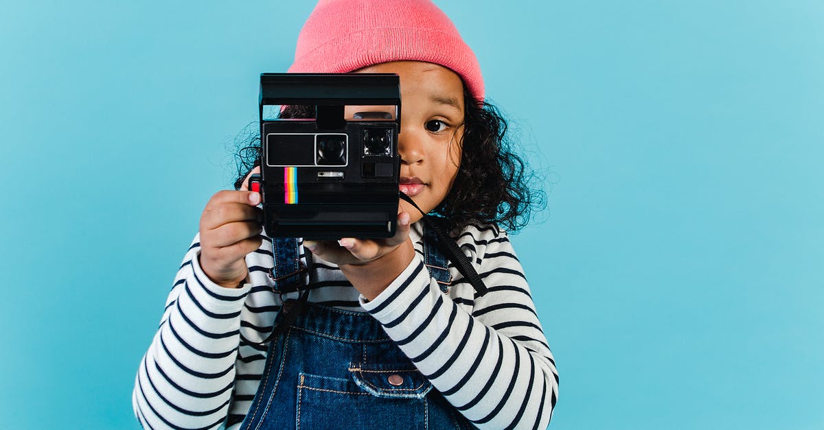 Why do film studios buy domains of fictitious companies? - Sweet black girl taking pictures on film camera