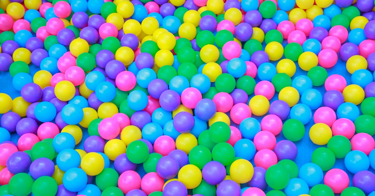 Why do kids shows have so many musical numbers - From above of colorful plastic balls in dry pool for kids to jump and play in playroom