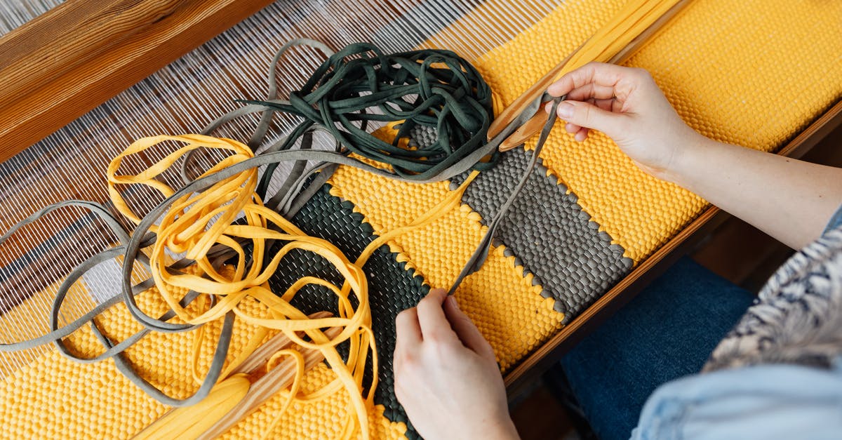 Why do so many movies feature the Dell Rugged laptop? - Top view of crop anonymous female employee working on wooden weaving loom machine with stretched durable colorful threads in workshop