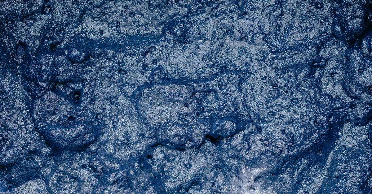Why do soap operas have the soap opera effect? - From above of surface of foamy indigo colored water during shibori tie dyeing process as abstract background