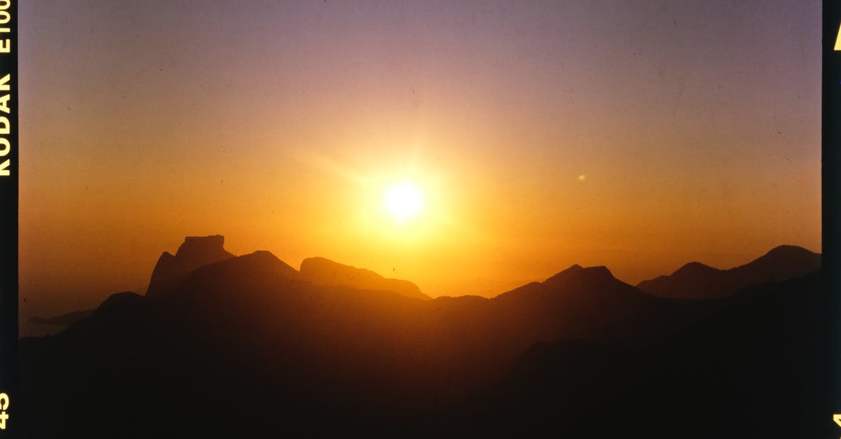 Why do some movies originally shot on film have notably vivid reds and skin tones? - Film picture of bright sun rising above black silhouette of mountains in early morning
