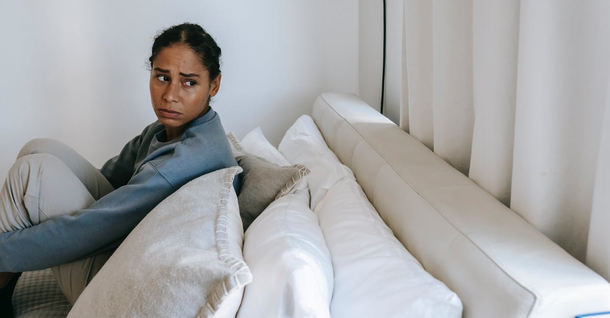 Why do the crew in Timeless worry about tracking quickly and recharge times etc? - Sad young African American woman spending time on white bed and thinking in casual outfit while looking away at home