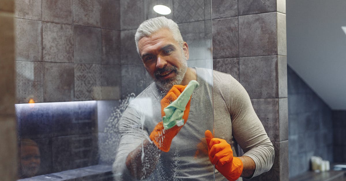 Why do the technicians on duty not care about what happening to Robocop when he's Dreaming? - Grey haired male with beard in rubber gloves cheerfully cleaning shower glass shield