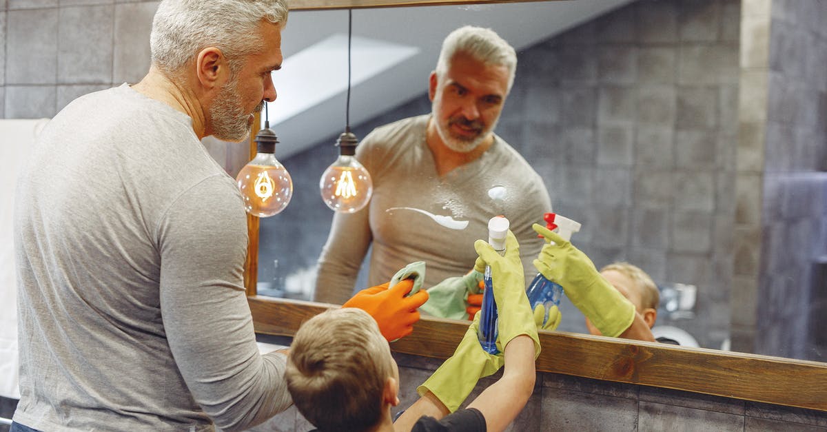 Why do the technicians on duty not care about what happening to Robocop when he's Dreaming? - Back view of small kid helping grey haired father with beard cleaning in bathroom