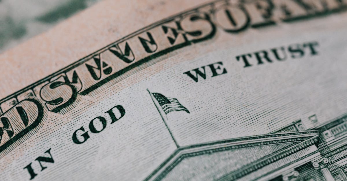 Why do we say that Captain America is the first avenger? - Closeup of ten dollar with inscription In God We Trust bill placed on table with different money