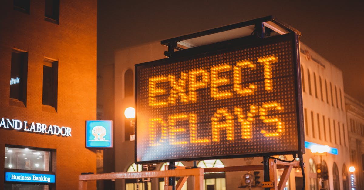 Why does air traffic control react a certain way in "The Strain" S01E01? - Mobile electronic traffic sign with inscription Expect delays placed on road in city street in evening time
