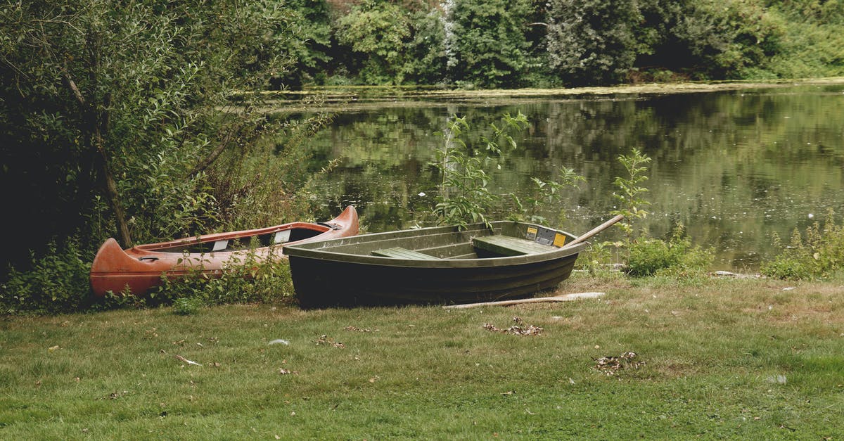 Why does Alice get the lake in with the kayak? - Two Black and Red Assorted-type Boats on Grass