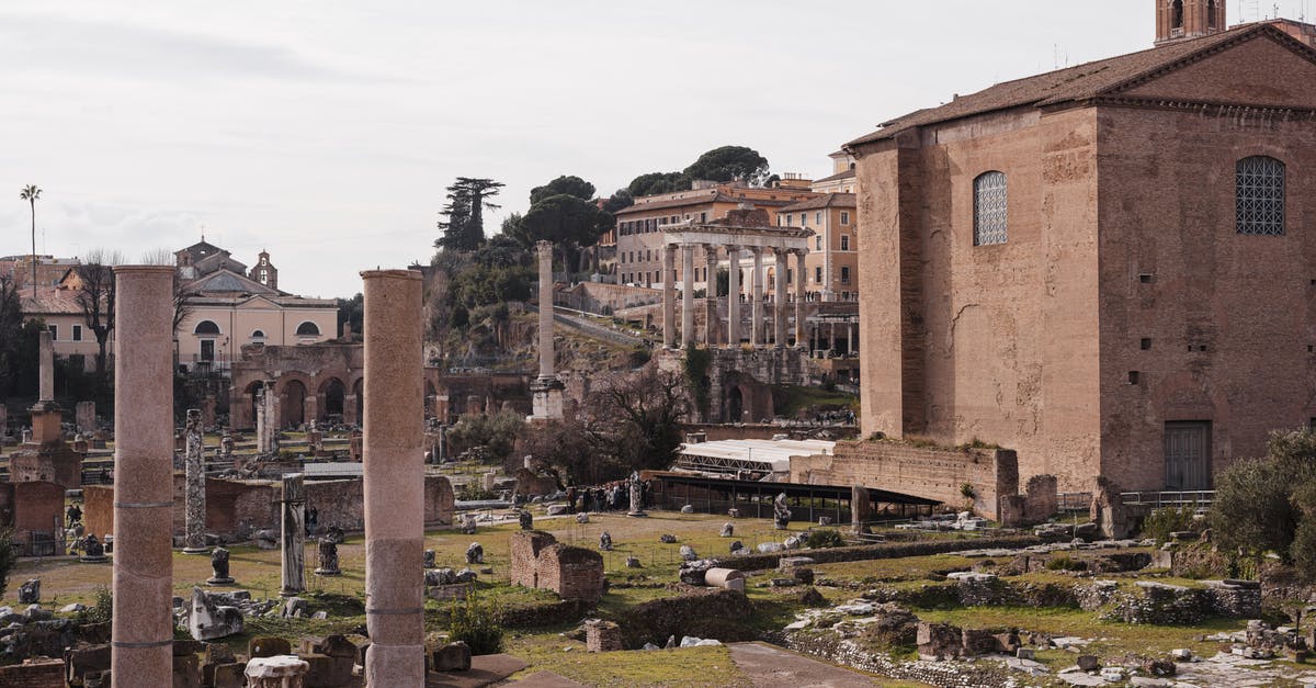 Why does Bane want to destroy Gotham city? - Roman Forum with old building facades and columns in city