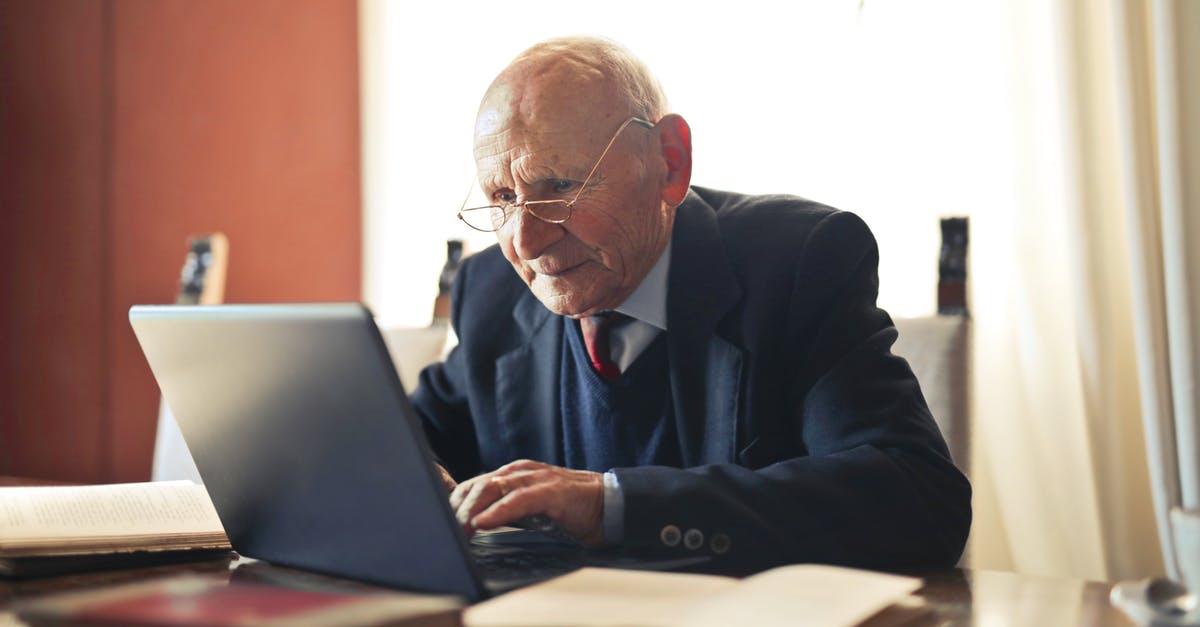 Why does Benedict's pit boss think Lyman Zerga is legit because he hasn't heard of him? - Concentrate elderly senior man in formal suit and eyeglasses working on laptop while sitting at wooden table with books in light room