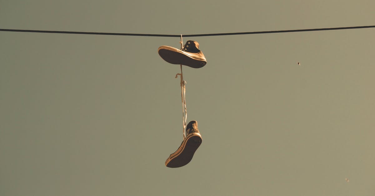 Why does Genie still have his powers after he was freed? - White Black High Top Shoes Hanging on Electric Line