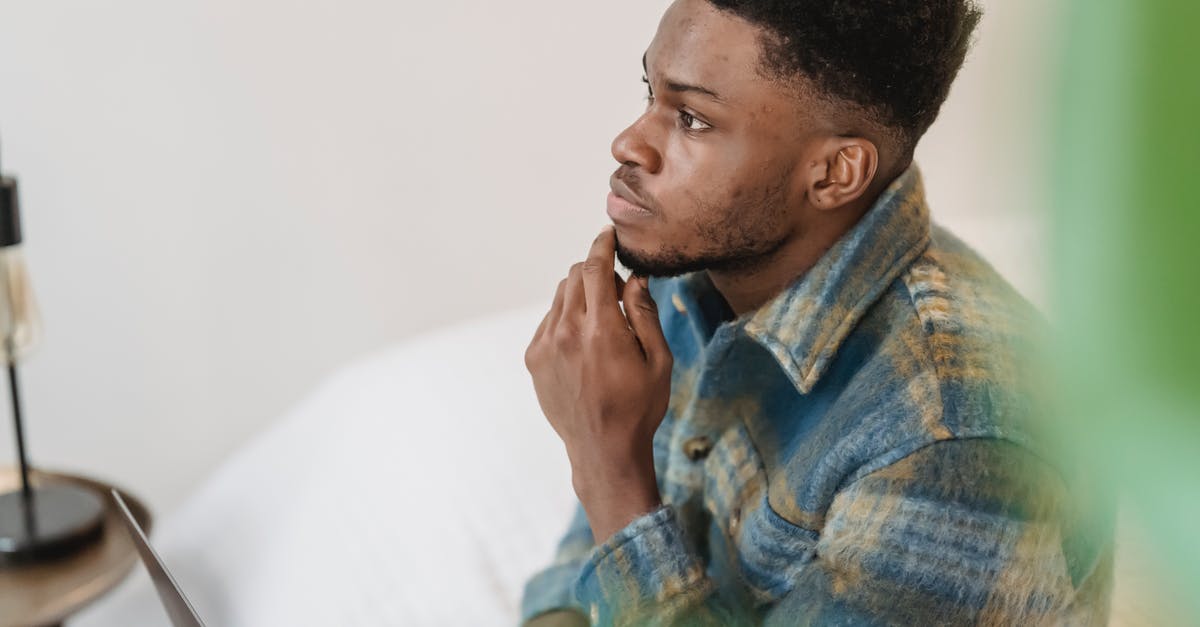 Why does Guy consider changing sex? - Pensive black man thinking in light room