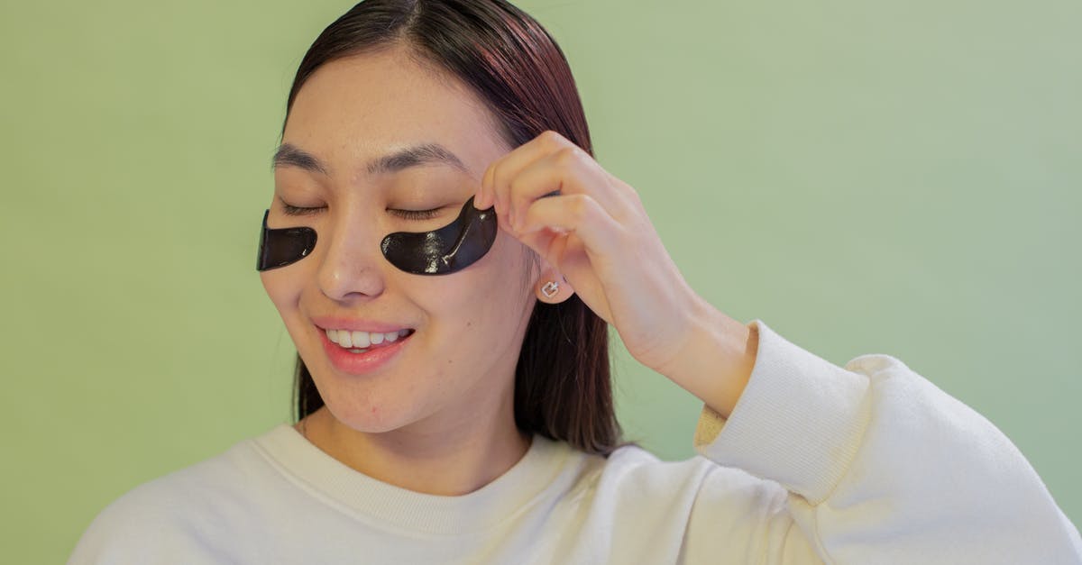 Why does Lily remove her panties in Black Swan? - Smiling Asian teen removing eye patch from face