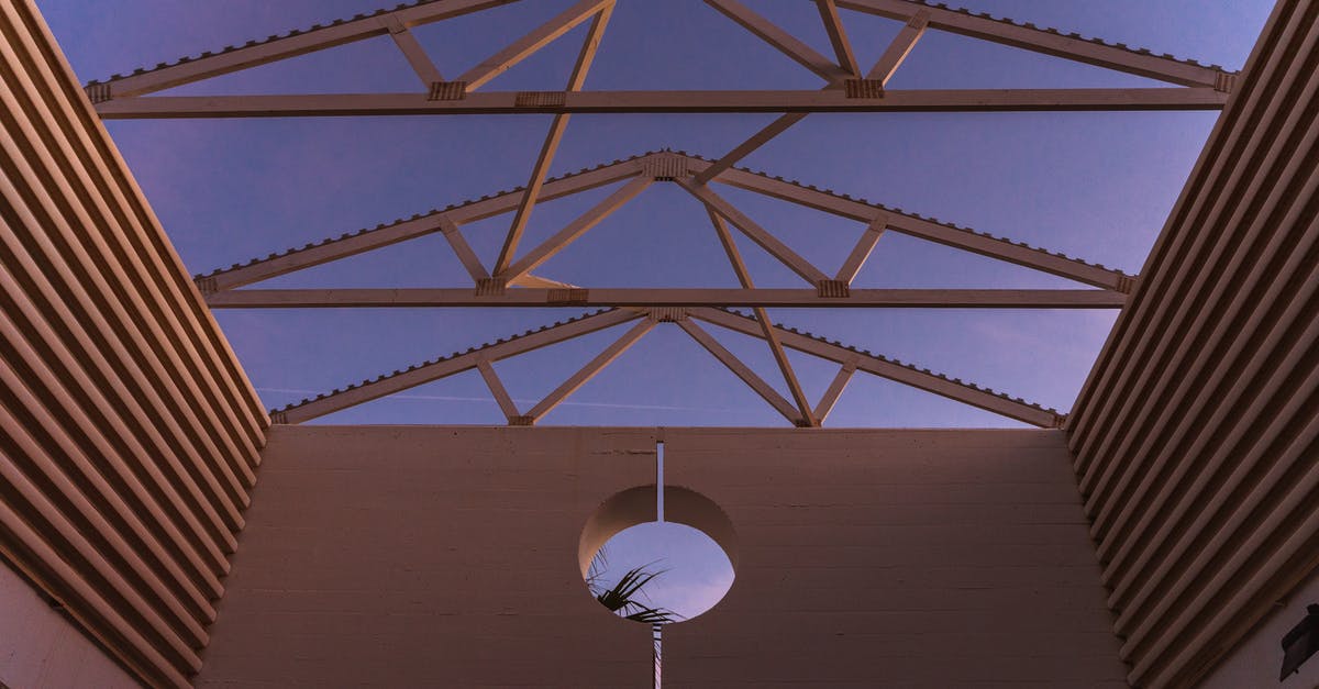 Why does Matt Damon cut a hole in the roof of the rover? - From below of contemporary building with ribbed walls and creative geometric construction on roof against purple sunset sky