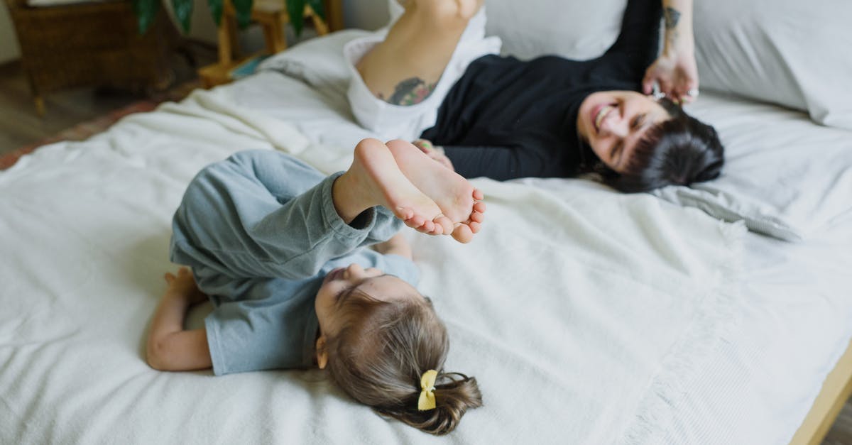 Why does Nick Sobotka have a pi tattoo? - Cheerful young mother with little child having fun on bed