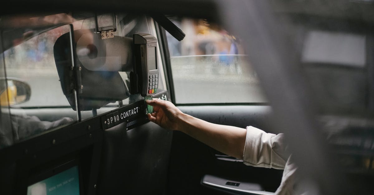 Why does not Sheldon use Taxi Cabs for his Transport issues? - Side view of crop faceless male passenger sitting on backseat and using credit card reader to pay for trip in taxi