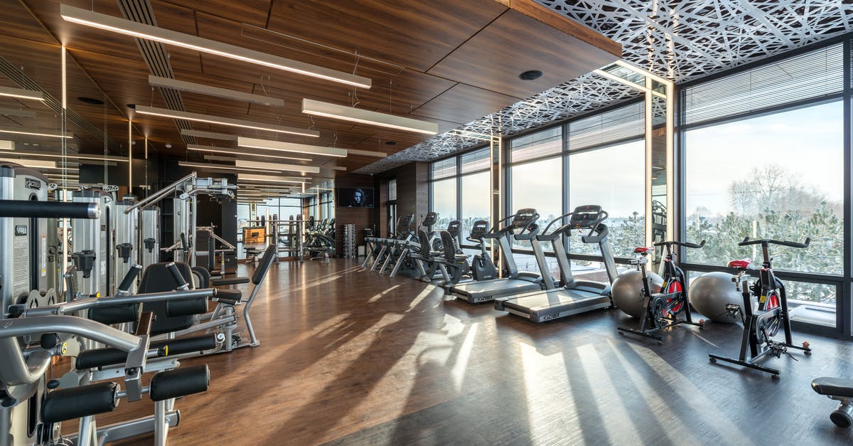 Why does PreCrime's machine report murders by carving names onto wooden balls? - Interior of modern fitness club with various machines and equipment