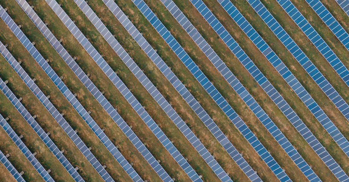 Why does removing Tony Stark's power source weaken him? - Textured background of solar panels in countryside field