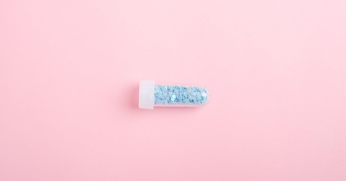 Why does S06E08 feature so many guest stars? - Top view of tube full of shimmering blue glitter for design and decoration on pink background