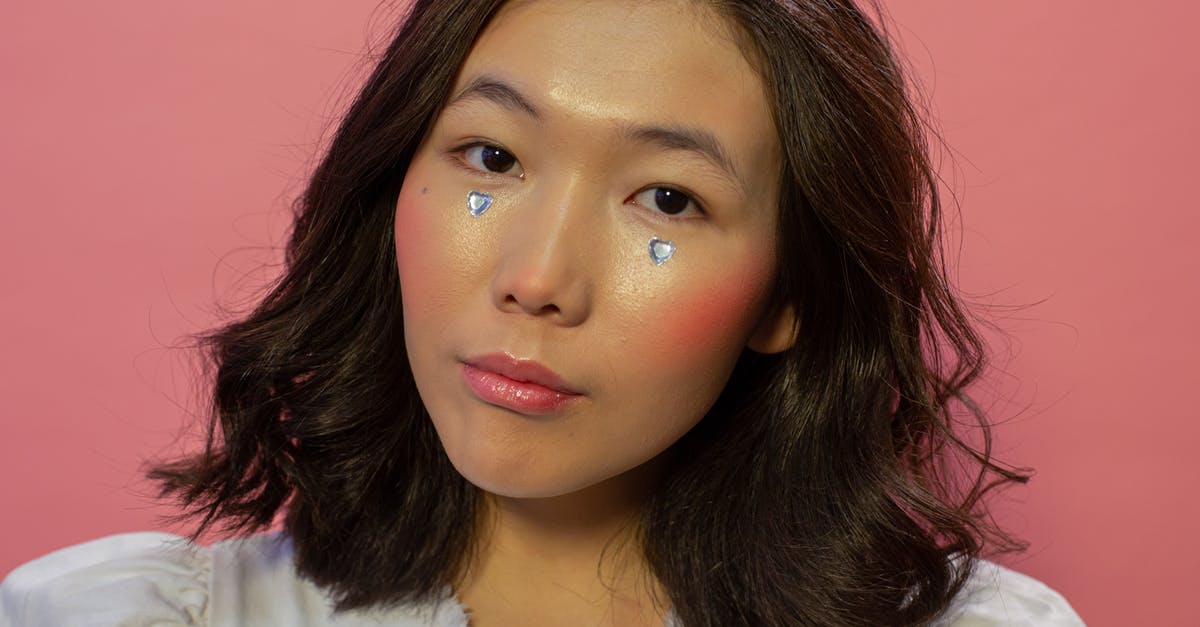 Why does SkekMal not appear to need the crystal to remain alive? - Serious Asian female with heart rhinestones on cheeks in studio