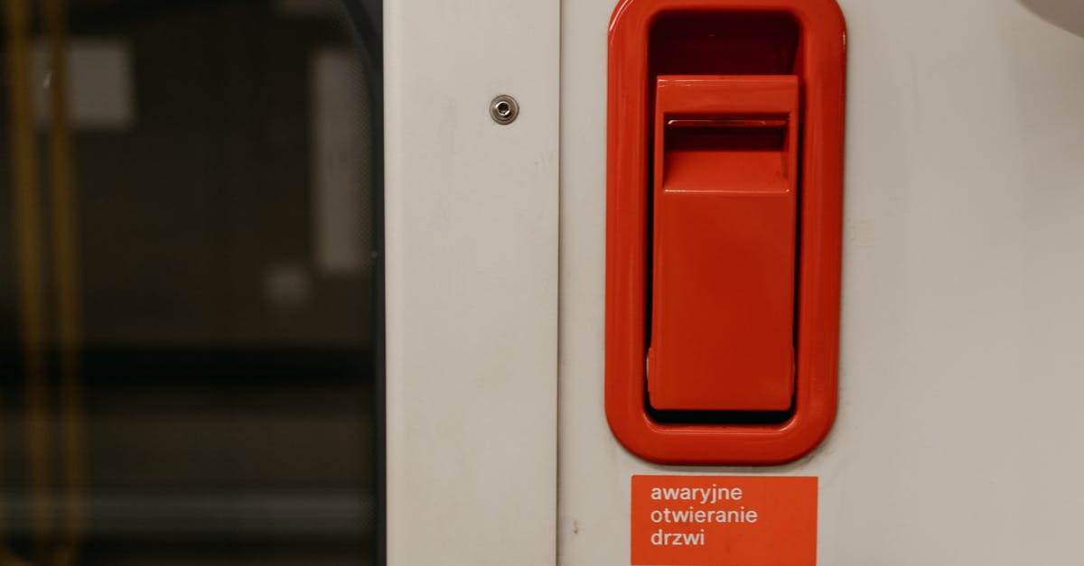 Why does Stormbreaker's handle stay? - A White Door with Red Lever Above a Warning Sign