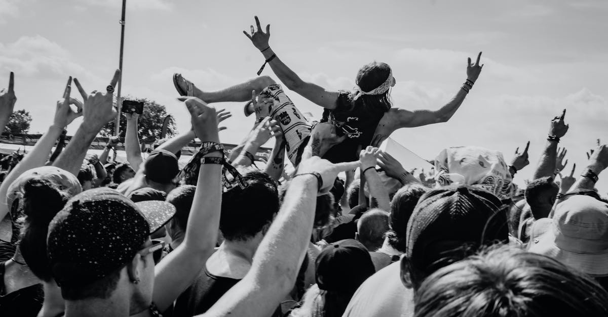 Why does the audience let Patty fall? - Grayscale Photo of People Raising Their Hands