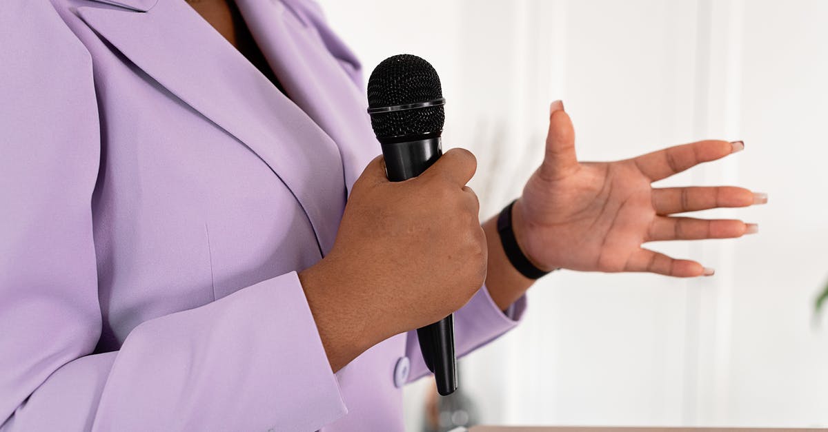 Why does the boom operator have to hold the boom mic by hand? - A Businesswoman Giving a Speech
