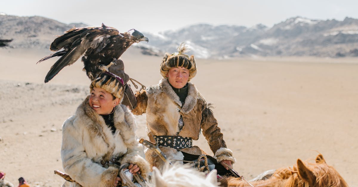 Why does the predator only come in the hottest seasons? - Positive Mongolian eagle hunters riding horses on mountainous terrain