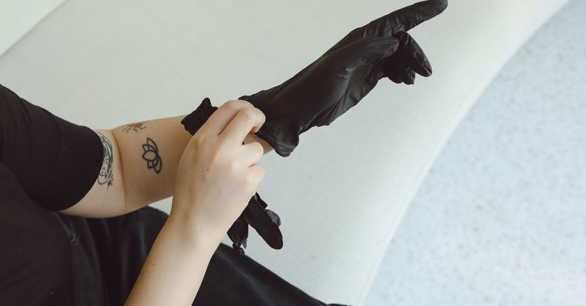 Why does Tyrell Wellick put on latex gloves in Elliot's apartment? - Person in Black Long Sleeve Shirt Holding Black Umbrella