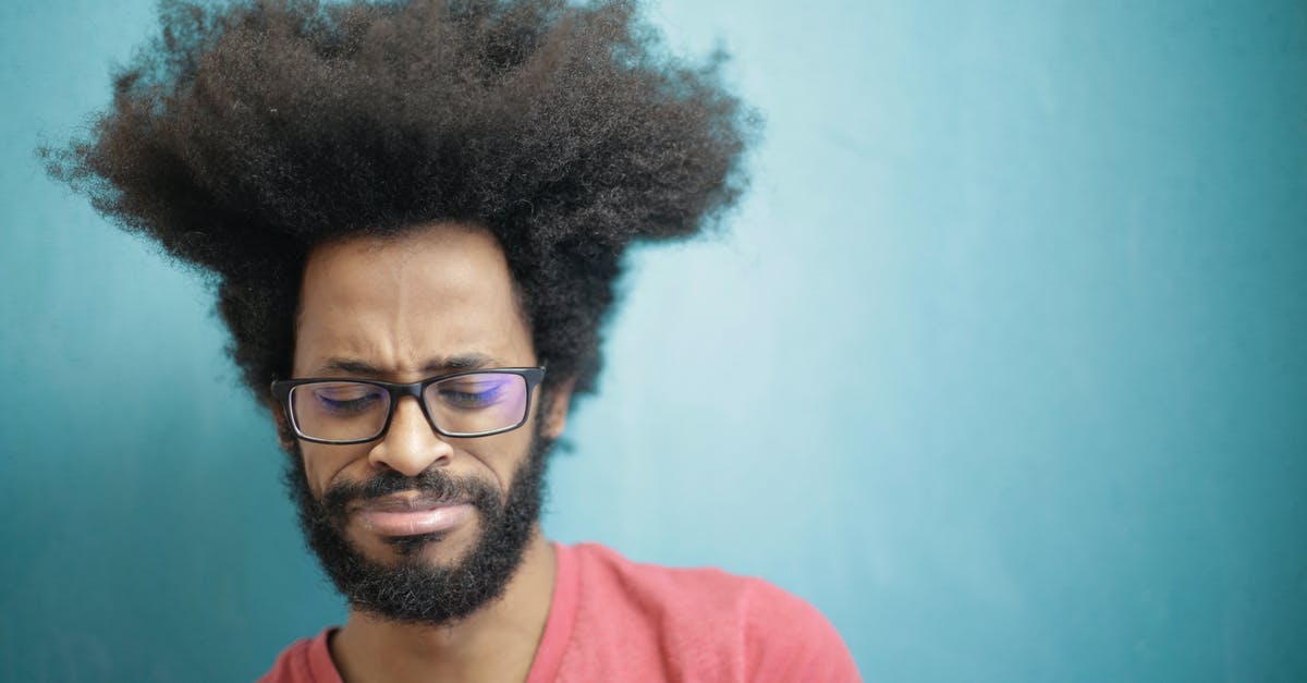 Why does Westley say Rodents of Unusual Size don't exist? - Young bearded ethnic male with creative Afro hairstyle wearing eyeglasses and pink t shirt looking down pensively thinking about trouble or question
