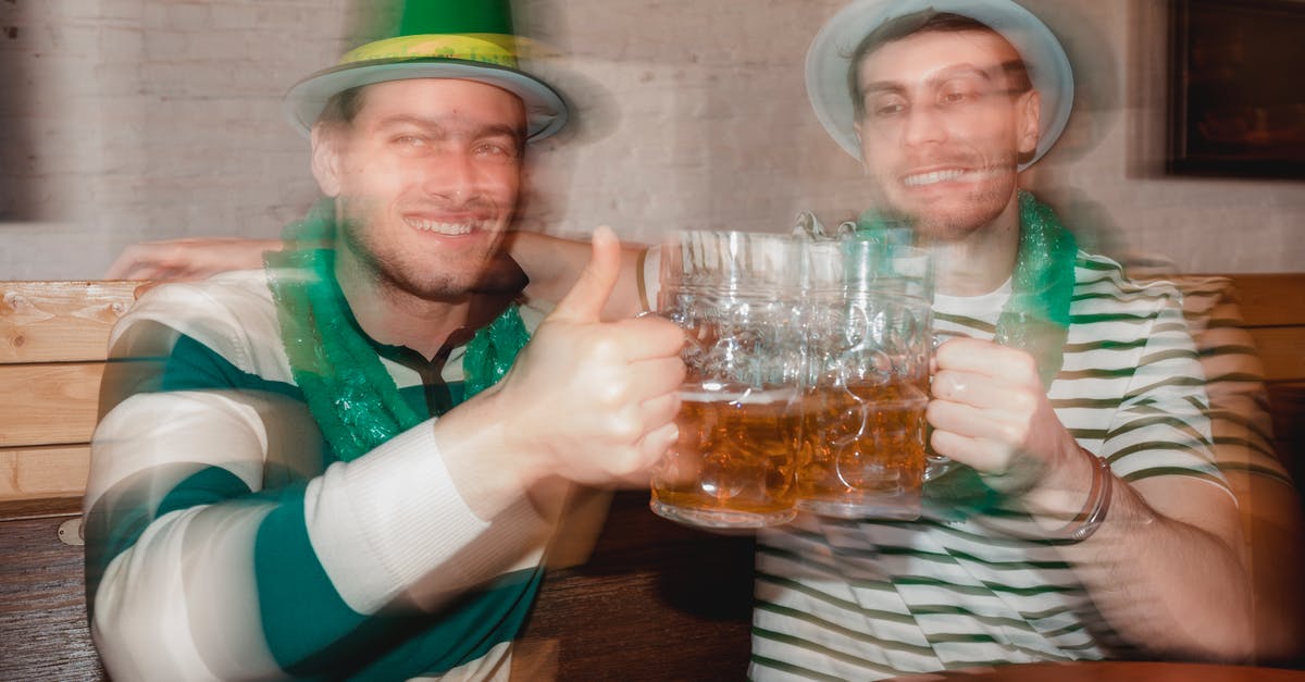 Why does Young Sheldon behave like an adult while Adult Sheldon behaves like a kid? - Content male partners in shamrock hats with jars of beer celebrating Feast of Saint Patrick at table in pub