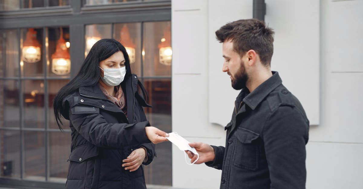 Why doesn't Agent 33 take off her mask in Agents of S.H.I.E.L.D. season 2? - Young couple with medical masks on city street during cold season